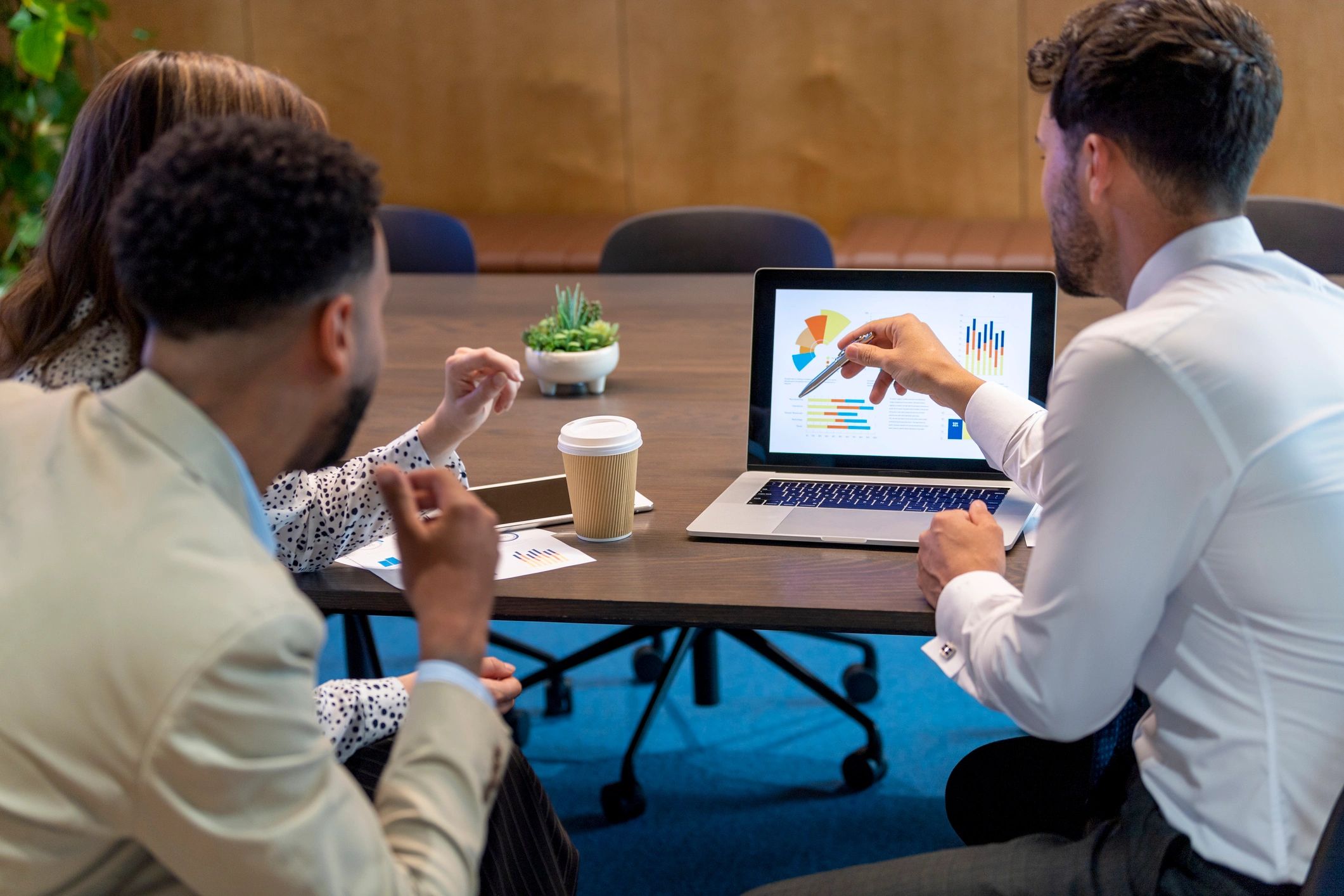 Financial advisor meeting with clients in a modern office